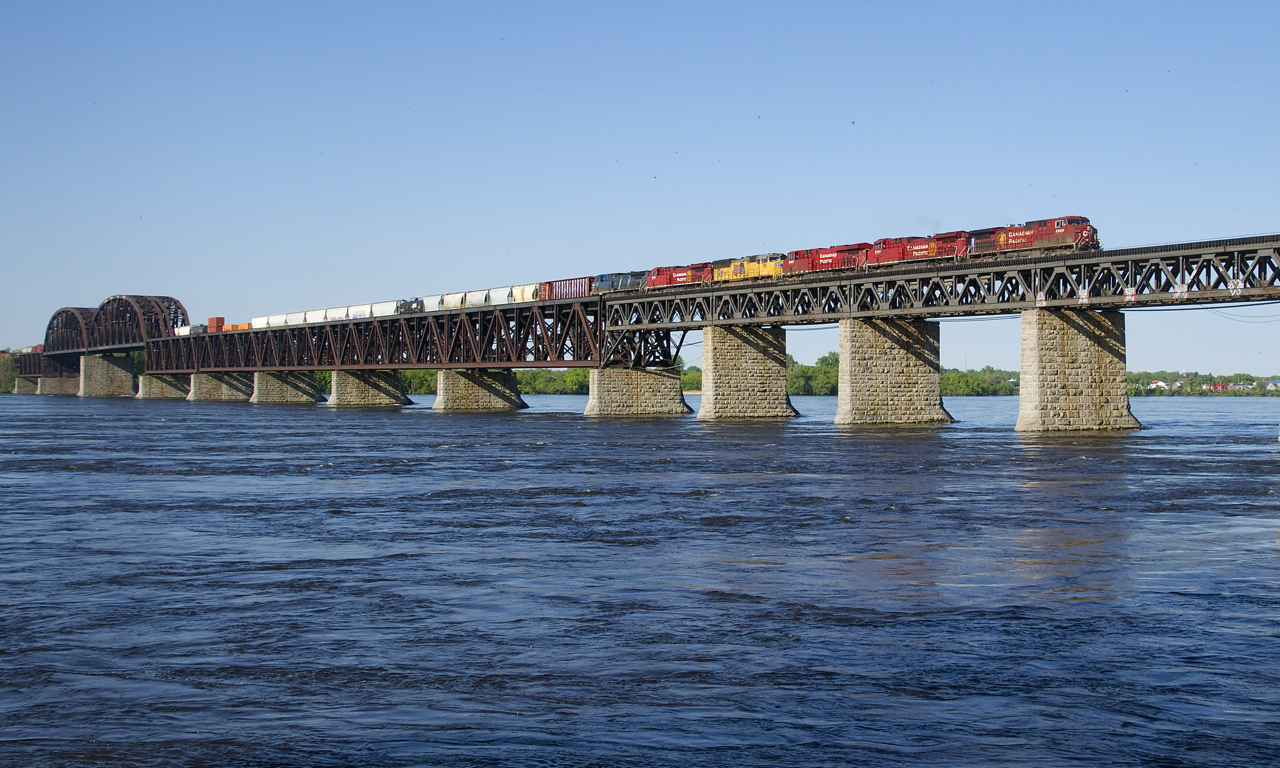CP 253 has 6 units (CP 8600, CP 8126, CP 8925, UP 3911, CP 8016 & CEFX 1032) and 77 cars as it crosses the St. Lawrence River towards Montreal on a beautiful morning.
