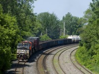 CN 324 rounds a curve on the Montreal Sub with NS 9448, CN 2971 & CN 3816 for power and 102 cars destined for the NECR in St. Albans, Vermont.