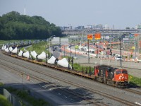 CN X311 with CN 2324 & CN 5787 for power rounds a curve on a fairly new section of CN's Montreal Sub as it approaches Turcot Ouest for a crew change. The train is carrying windmill blades, which are built by LM Wind Power Canada in Gaspé, Quebec.