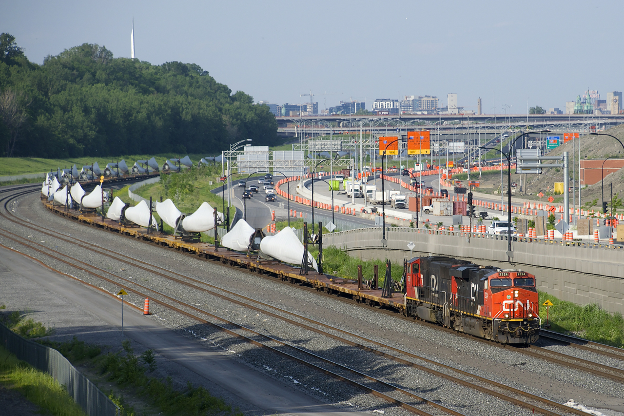 CN X311 with CN 2324 & CN 5787 for power rounds a curve on a fairly new section of CN's Montreal Sub as it approaches Turcot Ouest for a crew change. The train is carrying windmill blades, which are built by LM Wind Power Canada in Gaspé, Quebec.