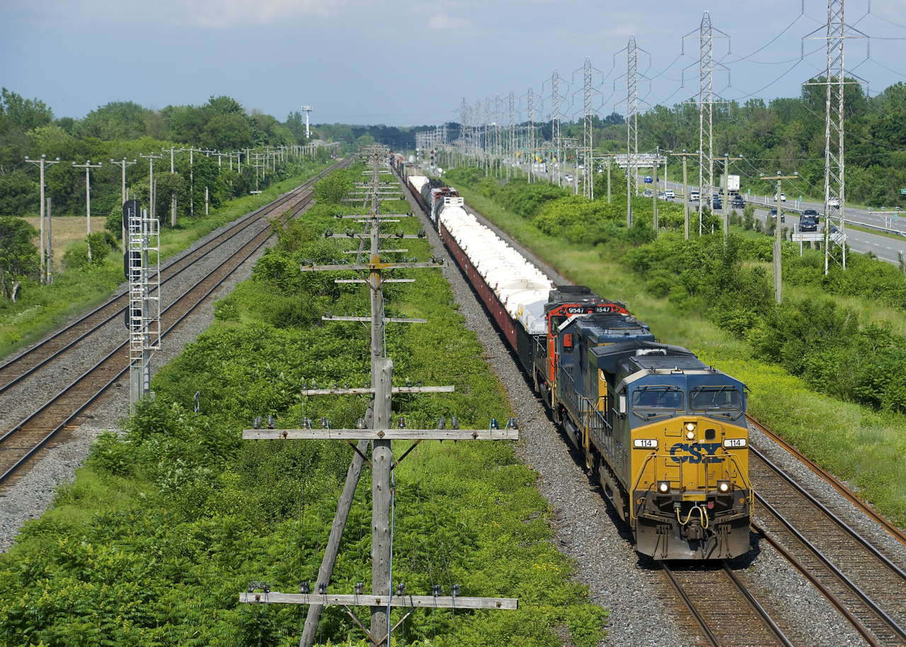CN 327 has CSXT 114, CSXT 8842 and CN 9547 for power and 84 cars as it prepares to leave the island of Montreal.