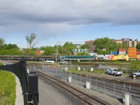 VIA 22 has three recently refurbished HEP cars in its consist as VIA 904 leads it past the Pointe St-Charles Yard.