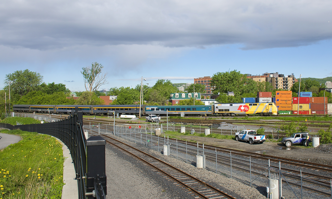 VIA 22 has three recently refurbished HEP cars in its consist as VIA 904 leads it past the Pointe St-Charles Yard.