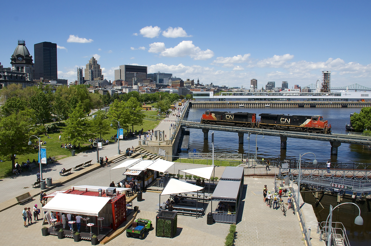 CN 527 with CN 2233 & CN 8853 is heading towards the Port of Montreal light power to pick up some cars. It is following the Pointe St-Charles switcher, which had just passed here in the same direction with 4 cars for the port.