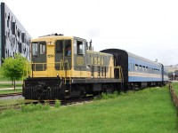 Privately owned GE 70-tonner 1556, leased to the Waterloo Central at the time, is shown departing Waterloo's faux-station for another trip to St. Jacobs.  The 1965 diesel looks out of place beside the modern Perimeter Institute of Theoretical Physics building. Fear not, because this scene has changed dramatically since the photo was taken.  The siding the train is on is now gone, and a double-track LRT line curves through here.  Waterloo Central no longer runs this far south.  The faux-station, built by an earlier attempt at a tourist train operation still stands, and is now a Visitor and Heritage Information Centre.  I assume with the arrival of the former OSR S13s on the Waterloo Central old 1556 was no longer needed and was returned to its owner.  It is now leased to and behind the fences of Babcock and Wilcox in Cambridge, which apparently has changed their name to BWXT Canada Ltd.   