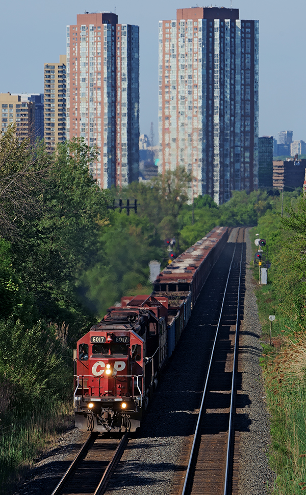 Much to my surprise to shoot SD40's still in service on the CPR, a pair of dual flagged veterans do the honors of pulling a loaded Herzog ballast train in full throttle up hill towards Toronto Yard.