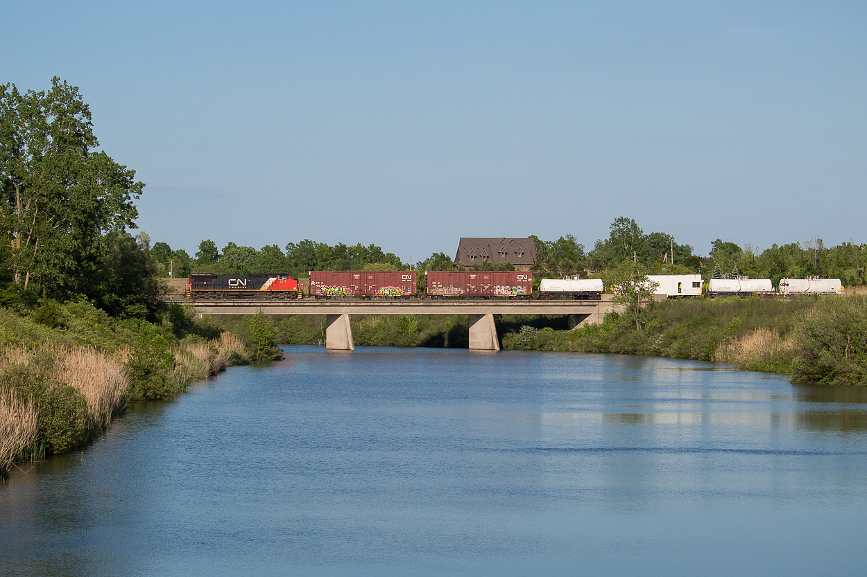 Running as 482 (at least as best I could tell), CN 2177 leads the CN spray train over the Welland River, just south of Port Robinson. The crew had sprayed the Grimsby and Stamford Subs today, and after running around their train in Fort Erie, returned long hood forward to Port Rob where they tied the power down for the night. They will wye it tomorrow before departing, as the train as only able to spray in one direction.