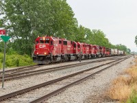 Five EMD units (four GP-38-2s and one SD60) and two GEs lead 255 off the siding in Welland as they begin to depart, heading north to work Kinnear next. The crew tried to put the GEs on point, but could not get air and, luckily for me, had to revert back to leading with 4439. <br><br> The track in the foreground is the CASO Spur, which heads west straight as an arrow for about 11 miles to the junction with the Dunnville Spur. This trackage all exists for one customer - Innophos in Port Maitland. Innophos is served by TE21 (Welland Yard night job) twice a week. 