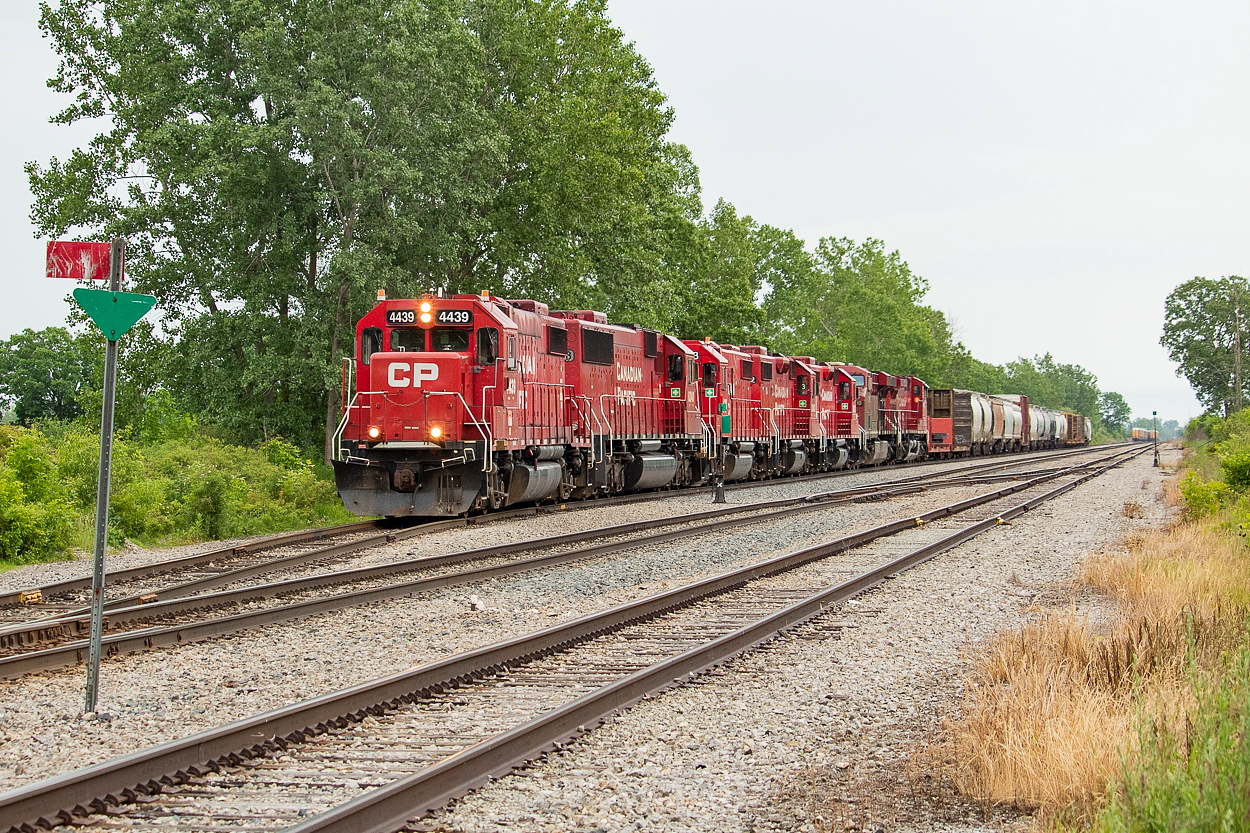 Five EMD units (four GP-38-2s and one SD60) and two GEs lead 255 off the siding in Welland as they begin to depart, heading north to work Kinnear next. The crew tried to put the GEs on point, but could not get air and, luckily for me, had to revert back to leading with 4439.  The track in the foreground is the CASO Spur, which heads west straight as an arrow for about 11 miles to the junction with the Dunnville Spur. This trackage all exists for one customer - Innophos in Port Maitland. Innophos is served by TE21 (Welland Yard night job) twice a week.