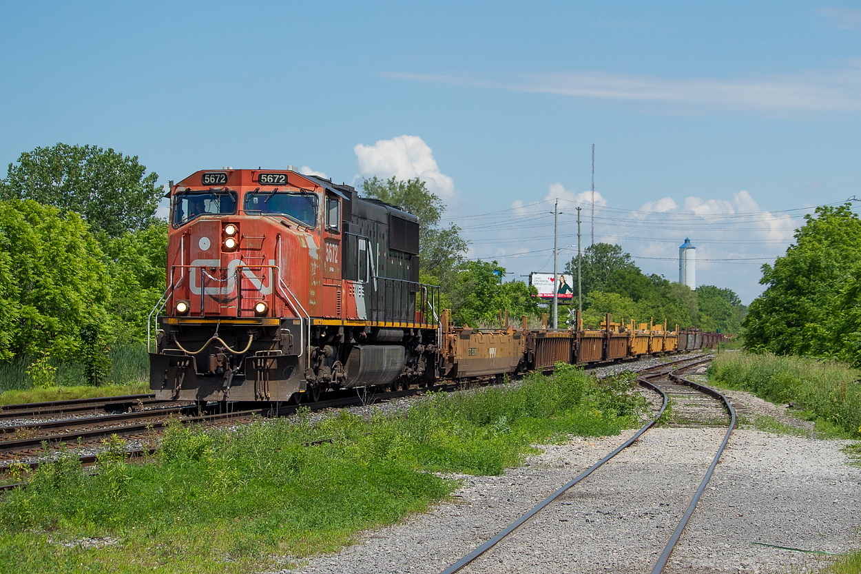 X107 with the 5672 solo heads through St. Catharines with a long train of empty well cars lifted out of storage in Fort Erie.