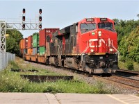 CN 3085 leads a lengthy 148 through Georgetown just before noon on a cloudless summer morning. 