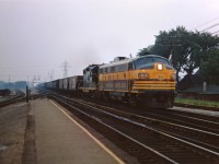 Ontario Northland FP7 1515 leads a CN GP9 (45xx) and and ore empties from the Oakville sub onto the Halton on a dull day in August 1967. An ON locomotive pooled with CN power was a bit unusual in the mid-1960s but did occur on a regular basis.