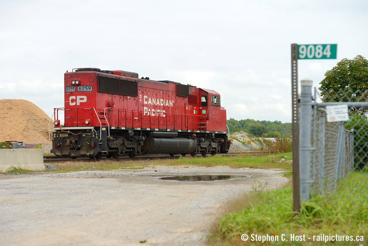 An odd scene as 6259 turns on the wye to bring a rail train east (was facing west). 9084 is the fire code for the CPR station/crew office at Guelph Junction that was built to replace the Guelph Junction station.Thank goodness those concrete barriers didn't go any further.