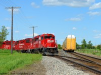 A weekend extra local out of Wolverton or Hagey (I'm not sure which) is working Canwell Building Materials off Dumfries Rd in North Dumfries Ontario. The train has loaded autos out of Hagey Yard and had a single centrebeam to set off here. I've never seen a train work this spur over the last 15 years being in the area but it does get cars - just have to be there at the right time.