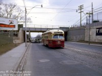TTC PCC 4375 (an A6-class car built new by CC&F in 1947/48) operates on a Saturday run of the Coxwell streetcar known as the "Kingston Road-Coxwell" route, heading northbound to Danforth Avenue on Coxwell Avenue after having just passed under the CN Kingston Sub underpass between Hanson and Gerrard. The clean silver/grey plate girder bridge with "modern" CN noodle logo is a nice touch. The fairly simplistic advertisement on the billboard is for the National Employment Office.<br><br>Regular weekday Coxwell route service ran along Coxwell Avenue between loops at Danforth and Queen, but as per <a href=https://transit.toronto.on.ca/streetcar/4116.shtml><b>Transit Toronto's Coxwell streetcar</b></a> route history, evening, weekend and holiday service at the south end was extended east from Coxwell along Queen-Kingston Rd. to Bingham Loop near Victoria Park. When the Bloor-Danforth subway was opened a little under a year later in February 1966 the Coxwell streetcar service was discontinued, although tracks remained on a few portions of Coxwell for deadheading cars (and still do between Gerrard and Queen).<br><br><i>John F. Bromley photo, Dan Dell'Unto collection slide.</i>