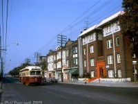 TTC PCC 4434 (an A7-class streetcar built by CC&F in 1949) heads eastbound on Queen Street East passing a row of storefronts and apartment buildings by the corner of Brookmount Road (that today all still remain, including the church in the background). Visible signage advertises Bedroom Apartments (w/Vacancy), Kay's Confectionery, and Globe Cleaners. On the south side of the street by the streetcar car stop to the left is the barely visible east end of the old Greenwood Racetrack, that once occupied the large piece land in this area of Toronto known as "The Beaches". It's a Monday, but it's also Thanksgiving Day, hence the very low level of holiday traffic on Queen.
<br><br>
<i>John F. Bromley photo, Dan Dell'Unto collection</i>.