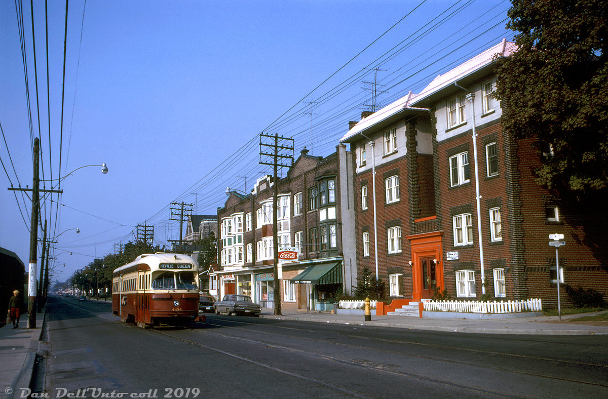 TTC PCC 4434 (an A7-class streetcar built by CC&F in 1949) heads eastbound on Queen Street East passing a row of storefronts and apartment buildings by the corner of Brookmount Road (that today all still remain, including the church in the background). Visible signage advertises Bedroom Apartments (w/Vacancy), Kay's Confectionery, and Globe Cleaners. On the south side of the street by the streetcar car stop to the left is the barely visible east end of the old Greenwood Racetrack, that once occupied the large piece land in this area of Toronto known as "The Beaches". It's a Monday, but it's also Thanksgiving Day, hence the very low level of holiday traffic on Queen.

John F. Bromley photo, Dan Dell'Unto collection.