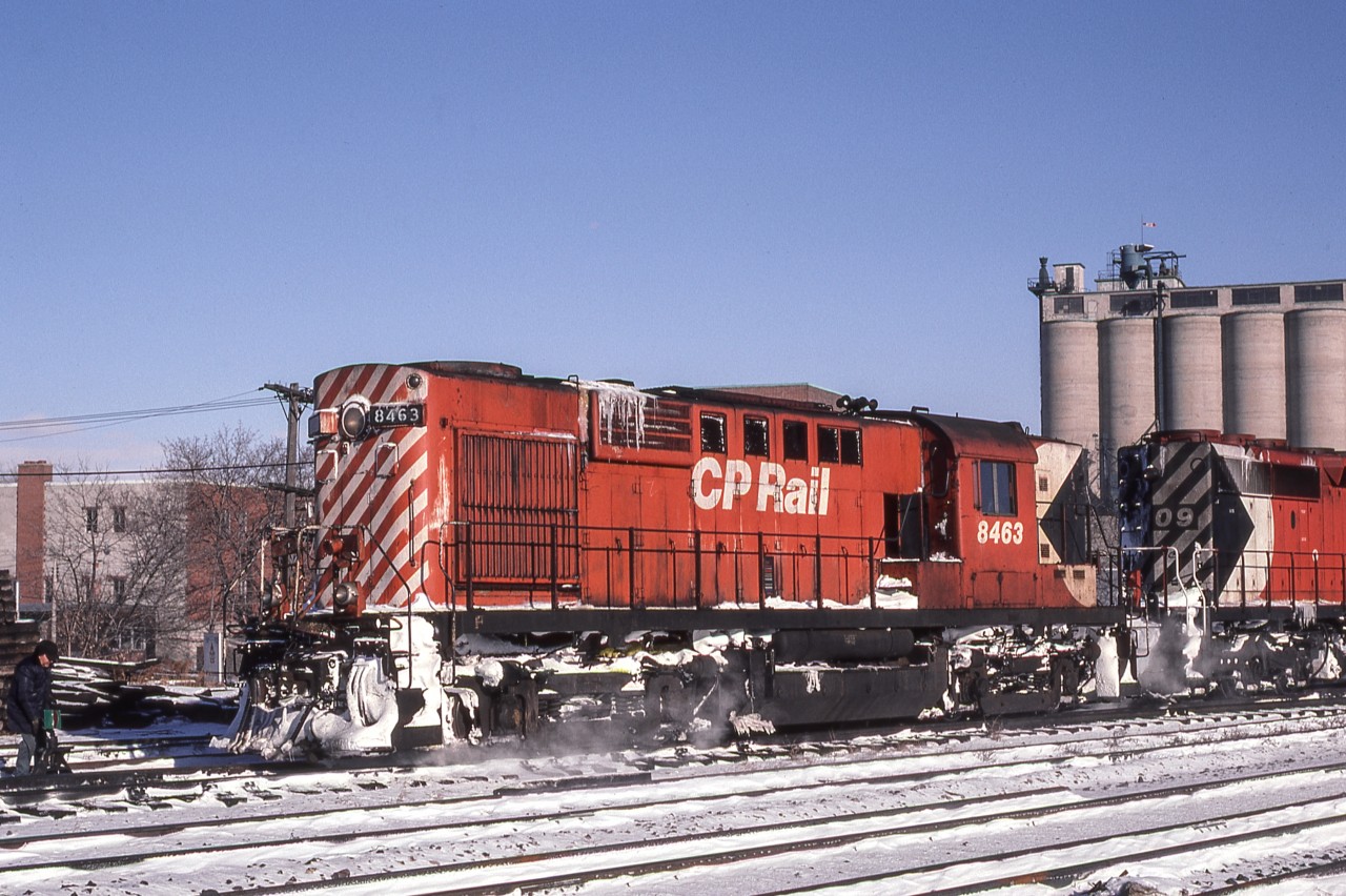 Peter Jobe photographed CP 8463 in Toronto on December 14, 1980. While some see only a roster shot, the man on the far left throwing the switch and the silos in the background add interest.