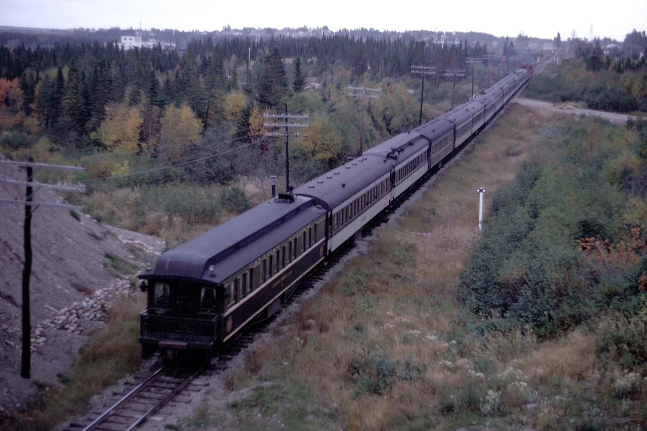 Last Look.  July 2, 1969, marked the last eastbound departure of the fabled Caribou, aka the "Newfie Bullet."  A living legend became one of dreams and memories the next day as Train 102 arrived in St. John's.  My last encounter with the Caribou was here, emerging from an overpass on the Trans-Canada Highway just west of Deer Lake on a dreary afternoon, Wednesday, October 9, 1968.  Fellow railfans Terry Thompson and Ted Wickson and I travelled from Ontario in Terry's new VW bug to sample the delicacies of railroading on Canada's East Coast.  We paid particular attention during our week to PEI and Newfoundland as their passenger trains were under intense threat of termination. Sporting the markers that afternoon was Inspection Car 3 which had been built for the Read Newfoundland Railway in 1903.  It, too, would end its days on the Island.  It was burned at the informal reclamation yard in Whitbourne in 1975.