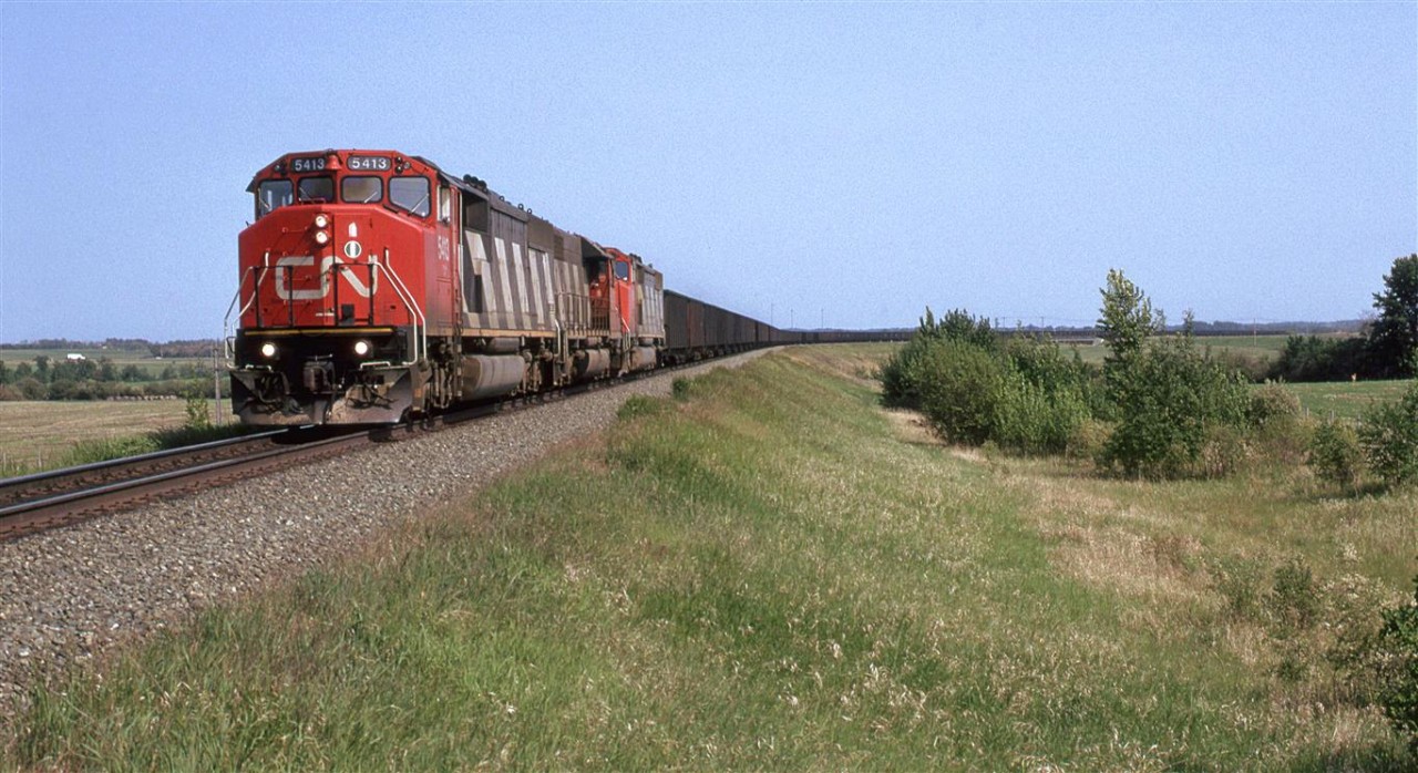 Even back then, when Bremnar existed, this may have been closer to Clover Bar.....Bremnar siding started just a little beyond the end of the train. Now, I think houses would be seen in that area on the right side of the photo.
This was the one coal train that went east from the Foothills Sub (Hinton AB). I had seen it loaded only occasionally. The empty train seemed to run through more often when I was trackside.