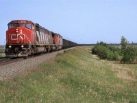 Even back then, when Bremnar existed, this may have been closer to Clover Bar.....Bremnar siding started just a little beyond the end of the train. Now, I think houses would be seen in that area on the right side of the photo.
This was the one coal train that went east from the Foothills Sub (Hinton AB). I had seen it loaded only occasionally. The empty train seemed to run through more often when I was trackside.