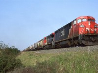 Not a particularly interesting photo location, but the locomotives might be otherwise....
An couple different generations of GE's team up to bring this empty grain train into Edmonton. Little did we know at the time that this was future.