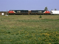 After fiddling around Brettville Junction, we decided to leave town to the west and check out Carvel. There, the Edson Sub swings around Mink Lake. 
First train up was a westbound grain with a couple cowled GE's leading. Both are from the second batch of that model ordered. 
