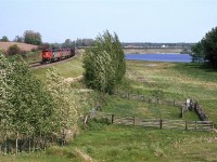 I was trying to get the "feeling" of railfanning Carvel with this shot. I had been looking at RR books and CTC Board magazine (Remember that?) and I noticed that the photos that most intrigued me were those that incorporated a sense of place. For those that know the area, did I succeed?
Oh, by the way, this is the coal train returning to the mines at Coal Valley (from Thunder Bay). The suspected phosphate train can be seen on the north track, over the coal gondolas.