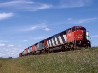 Hillbilly A/C and 5 locomotives.
4 cowled units and a GP-9u lead this manifest train east, between Spruce Grove and Edmonton.