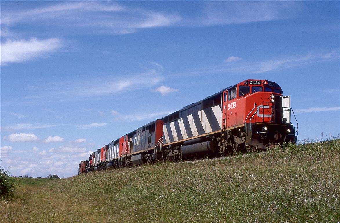 Hillbilly A/C and 5 locomotives.
4 cowled units and a GP-9u lead this manifest train east, between Spruce Grove and Edmonton.