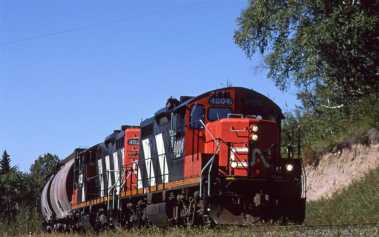 519 is heading back east toward Edmonton, but will likely stop at the other end of Wabamun Lake to drop the hoppers at the two coal fired power plants. The hoppers are for fly ash.
The Seba Beach area, at the west end if Wabamun Lake, sure has developed since '95