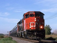 586 is eastbound on the Vegreville Sub for a brief time, before veering north on the Coronado Sub. At Abilene, it will take the Bonnyville Sub to Cold Lake (which the RR called Grand Centre). Cold Lake is the home of the Canadian Air Force base. Those tank cars in yow are full of aviation fuel, a very distinctive cargo that identifies the this train as 586. This train ran once, maybe twice a week.
If someone could help me out, I do not remember what that tall structure is at the extreme left, on the horizon.
