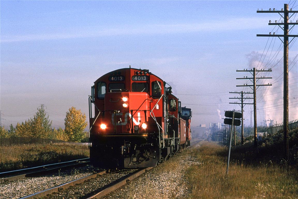 520 was a fairly predictable train out of Walker Yard. It would head out The Wainwright and then down the Camrose Sub in very favorable light. Today, they do not have much work. I don't think that they even went to Carmose, or even left Edmonton.
Steam rises in the still air at Celenese in the background. It not even October and the leaves have lost their chlorophyll.