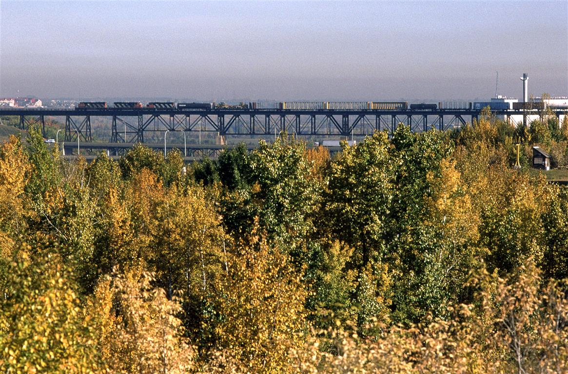 After dropping a substantail portion of their train in Clover Bar, 219 continues to Walker Yard where the train terminates.
This is a rather different view of the high bridge over the North Saskatchewan River.
The Edmonton Power plant seen at right is long gone.