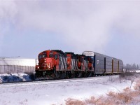 Steam from the nearby Celanese plant whitens the sky on an otherwise clear day. The Clover Bar Transfer has a few auto racks in tow to bring to Walker Yard from Clover Bar Yard. The cars may have come from the auto handling facility near Clover Bar, or they arrived on a train that dropped them at Clover Bar Yard, and will go out on a train from Walker.