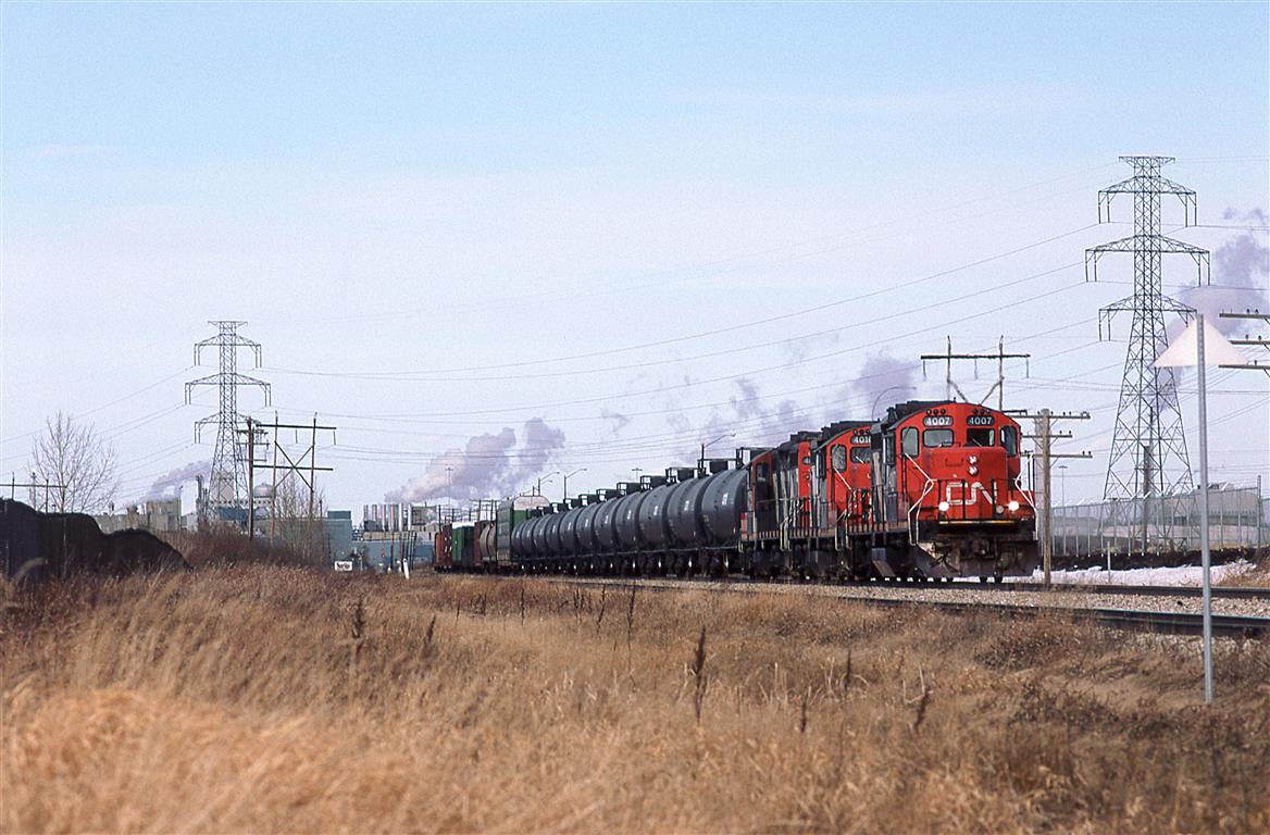 I am not exactly sure what is going on here, but the Clover Bar Transfer is headed south down the Camrose Sub with what would be a typical Clover Bar Yard to Walker Yard consist. Perhaps they are going to switch an industry down this way, before going to their destination.