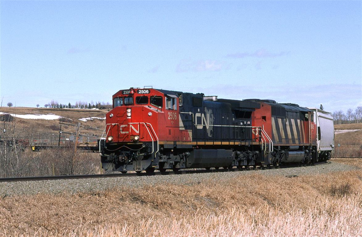 This is another area that I found by studying topo maps. The Camrose Sub winds down this valley from the town of Camrose to cross the Battle River Valley. My hopes were that I could obtain a view looking up this small valley from the south rim of the Battle River Valley. Trees and houses precluded that plan. I always wanted to explore this small valley for photo opportunities. I will manage to see the upper end but I was not able to really get to know the bottom  area. There are several wooden trestles in this small valley.
Ferlow Junction, in the Battle River Valley is where a branch splits off the Camrose sub. The branch, whose name escapes me, went to Stettler and may have been spun off to a tourist line at this time. That branch may be seen at far right.
444 is the daily Edmonton to Calgary manifest train.