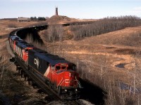 Vancouver to Strachan sulphur empties glides down Camrose Creek on the south side of Camrose. Strachan is west of Red Deer in the heart of a huge sour gas field. 