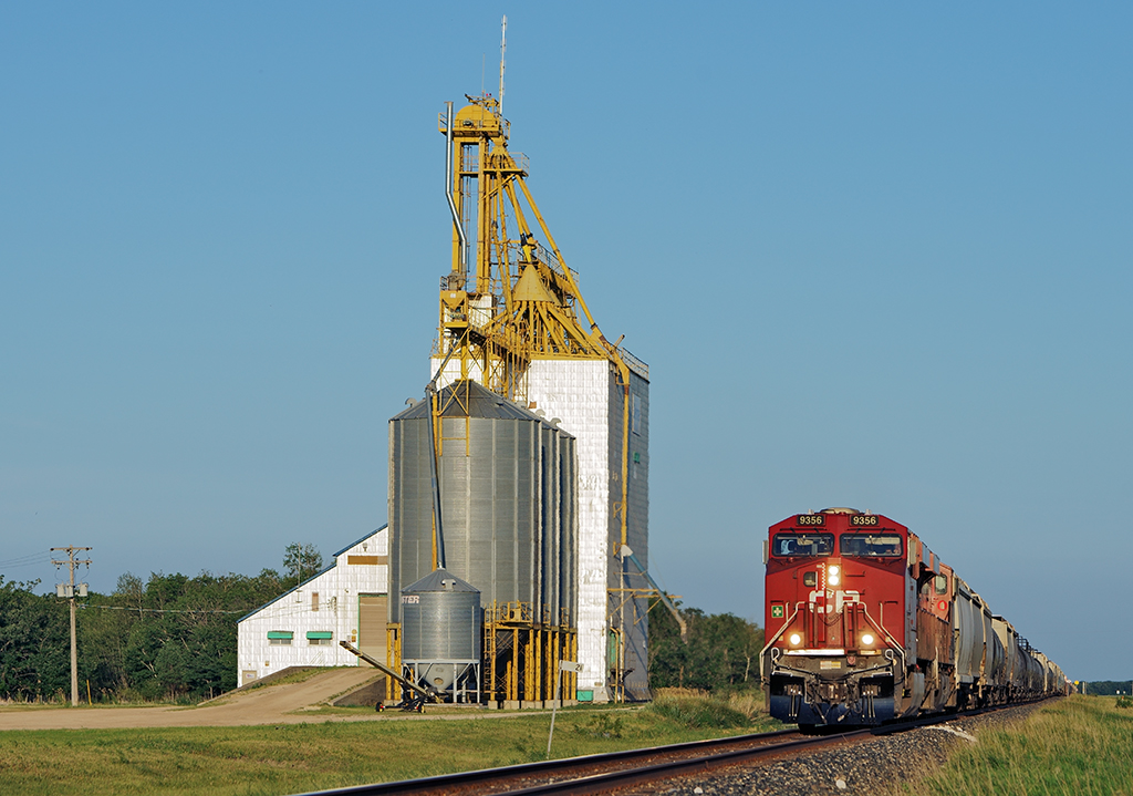 We are at Mile 21 of the Minnedosa Sub as westbound 299 passes one of many grain elevators along the line.