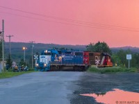CN local L578 heads into a spur to do a pick up of a cement car at sunset. The Grand Falls locals are perched near the tracks on their 4 wheelers. 