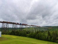 Leaser unit CREX 1518 is in charge of stack train Q121, as they rumble across the 3,920 foot Salmon River Trestle. 