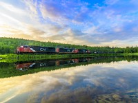 Running a few hours later than normal, train 406 heads by the unnamed lake, about an hour from sunset. The lake was nearly crystal clear, which obviously makes the shot that much better. 