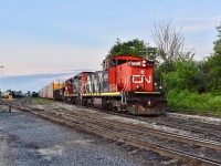 Wednesday night in Kitchener at exactly 9pm finds CN GMD-1U 1444 idling away at Kitchener yard on the passing track as it’s crew (who were likely called in for this extra a couple hrs earlier) prepare for their night at Huron Park. Trailing unit is gp9rm 7025. <br>
Earlier that day, the regular 540 which ran to Guelph consisted of this GMD-1 in the lead (1444) and two gp9rm’s trailing 7025 and 4138. Tonight 4138 (the third unit in 540’s consist) will work the Waterloo Spur solo on CN’s usual weeknight local in Kitchener 566 (their crew had also just showed up as they’re scheduled start time is 21:00) and 1444 will take the extra 540 down the Huron Park Spur with 7025 trailing.