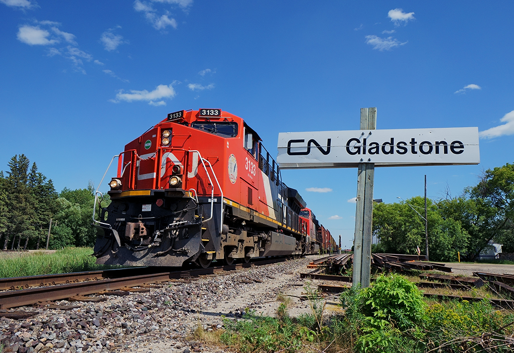 Sit in a hotel or rent a car and go places, I chose the later. CN3133 leads U75771 02 up the Gladstone Sub at mile 36.5 in the subdivisions namesake town for Dauphin, Manitoba.