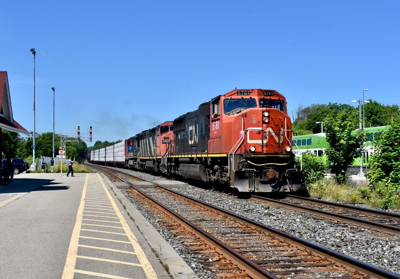 With sd75I 5761 on point, CN 384 motors through Georgetown GO eastbound shortly after 11 and it is a beautiful Sunny Sunday morning! Trailing units were C40-M8 2407 and Dash 8-40CW 2193 both in CN paint. There ended up being a few foamers actually who decided to take advantage and come to Georgetown this fine morning including I myself. The last railfan on the left at the end of the platform happens to be a well-known RP.ca contributor Jason Noe. His life long railfan Buddy Jason Bartlett is standing right next to him and we had one last detected railfan who goes by the name of Matthew and he is standing a bit closer to the train in the middle and taking photos of the power with his I-pad! Weekends on the Halton are always worth a try!