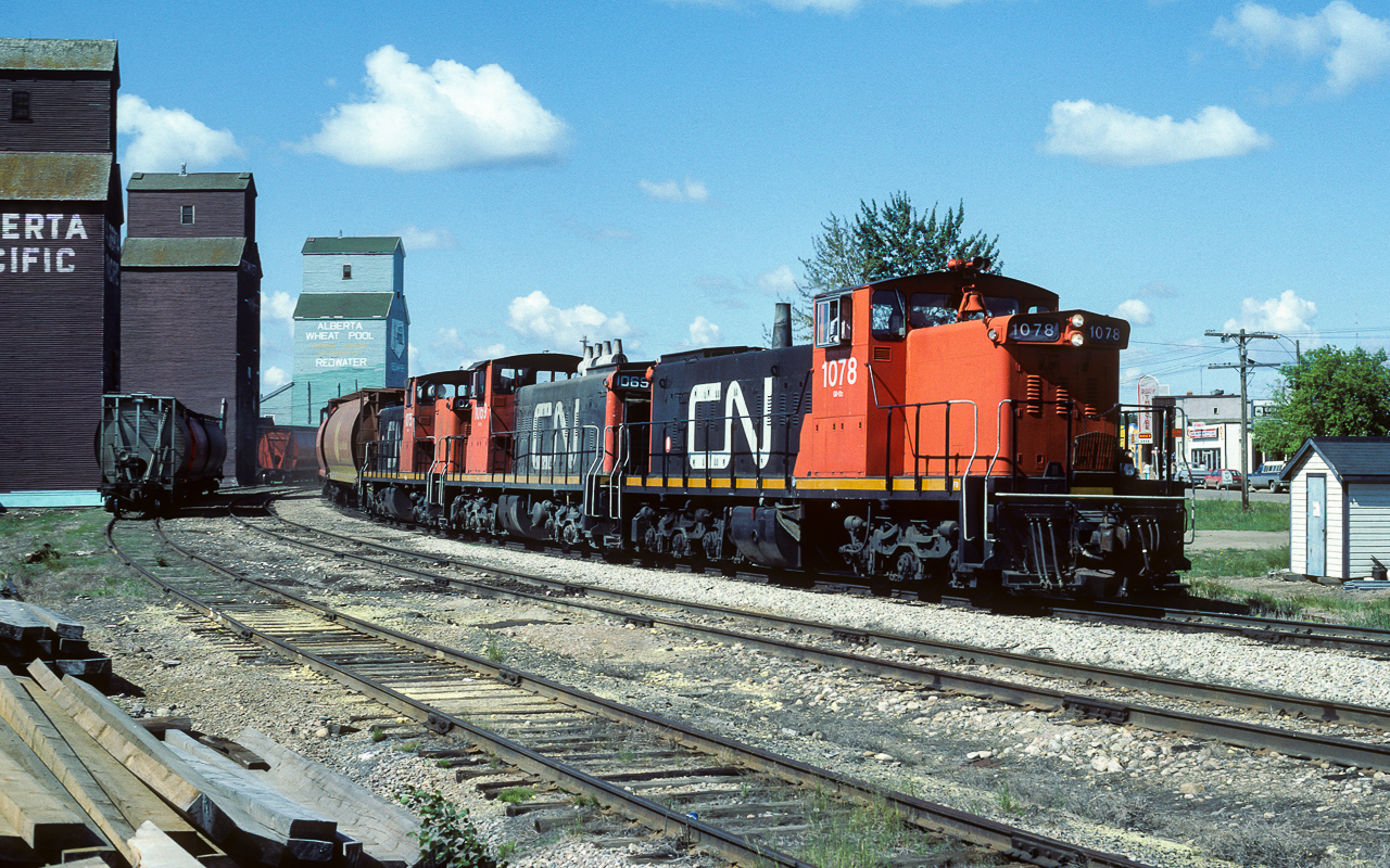 A photo to go with my last post. Almost the same spot, but, 34 years earlier. In my 2019 photo, I am closer to where the hoppers are and a little further away from the track. No SD40's allowed back then, the big power in 85 were the GP38's. Speaking of 85 and Eric Mays recent post and mention of 80lb rail. The mailine here is 85lb rail and the elevator track in the foreground is 60lb spaghetti rail. Hefty stuff :-) In this photo the 1078, 1069 and 1075 are passing through Redwater at 11:00 and headed for the air base at Cold Lake.