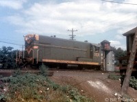 CN H12-44 1631 works at the east end of Mimico Yard at Church Street (the present-day Royal York Road underpass) in 1955. Note the Milnes Coal Co. dealer in the background, on the east side of Church St. to the north of the rail corridor (Milnes was a very popular coal dealer with multiple locations in the Toronto area, back when coal was used for home heating).
<br><br>
1631 was part of a 10-unit order of FM H12-44 switchers built by CLC in Kingston in 1955, making the unit only months old when this photo was taken. CN acquired 20 additional H12-44 units in 1956, and for most of their lives they were assigned out east (operating on lines in Quebec, Prince Edward Island, Nova Scotia and New Brunswick). By the mid-late 60's the switchers, along with the rest of CN's FM/CLC fleet, would be retired from the roster and scrapped.