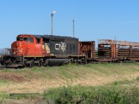 This train headed backwards out of Walker yard and arriving at Bretville Jct. took the north leg of the wye and then headed south down the east leg with engine and train traveling in the right direction. Photo'd here at East Edmonton at 11:30.