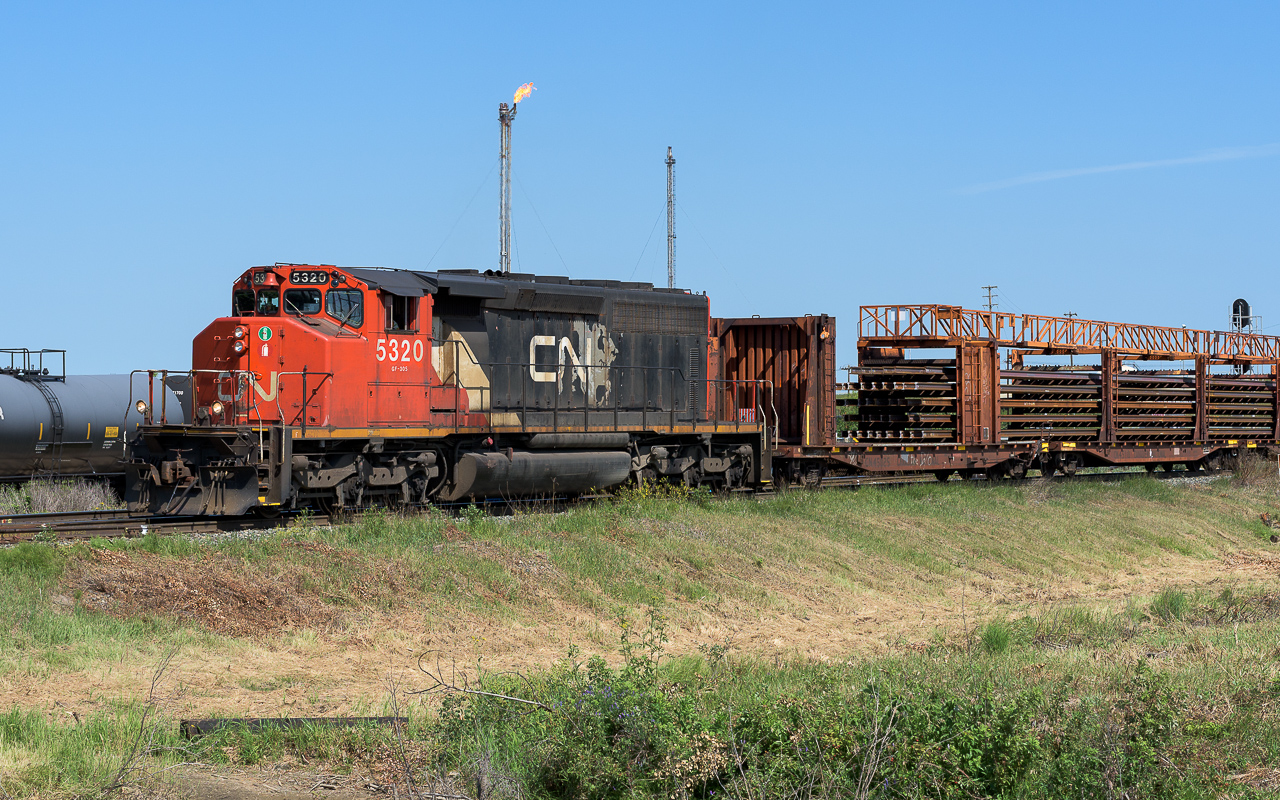 This train headed backwards out of Walker yard and arriving at Bretville Jct. took the north leg of the wye and then headed south down the east leg with engine and train traveling in the right direction. Photo'd here at East Edmonton at 11:30.