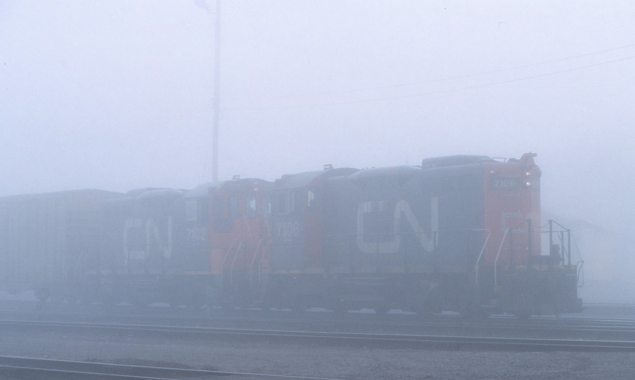 Dense early morning fog makes CN 7106 and 7102 appear almost ghost like as they work the yard in Capreol, Ontario prior to heading to Sudbury with a short train.